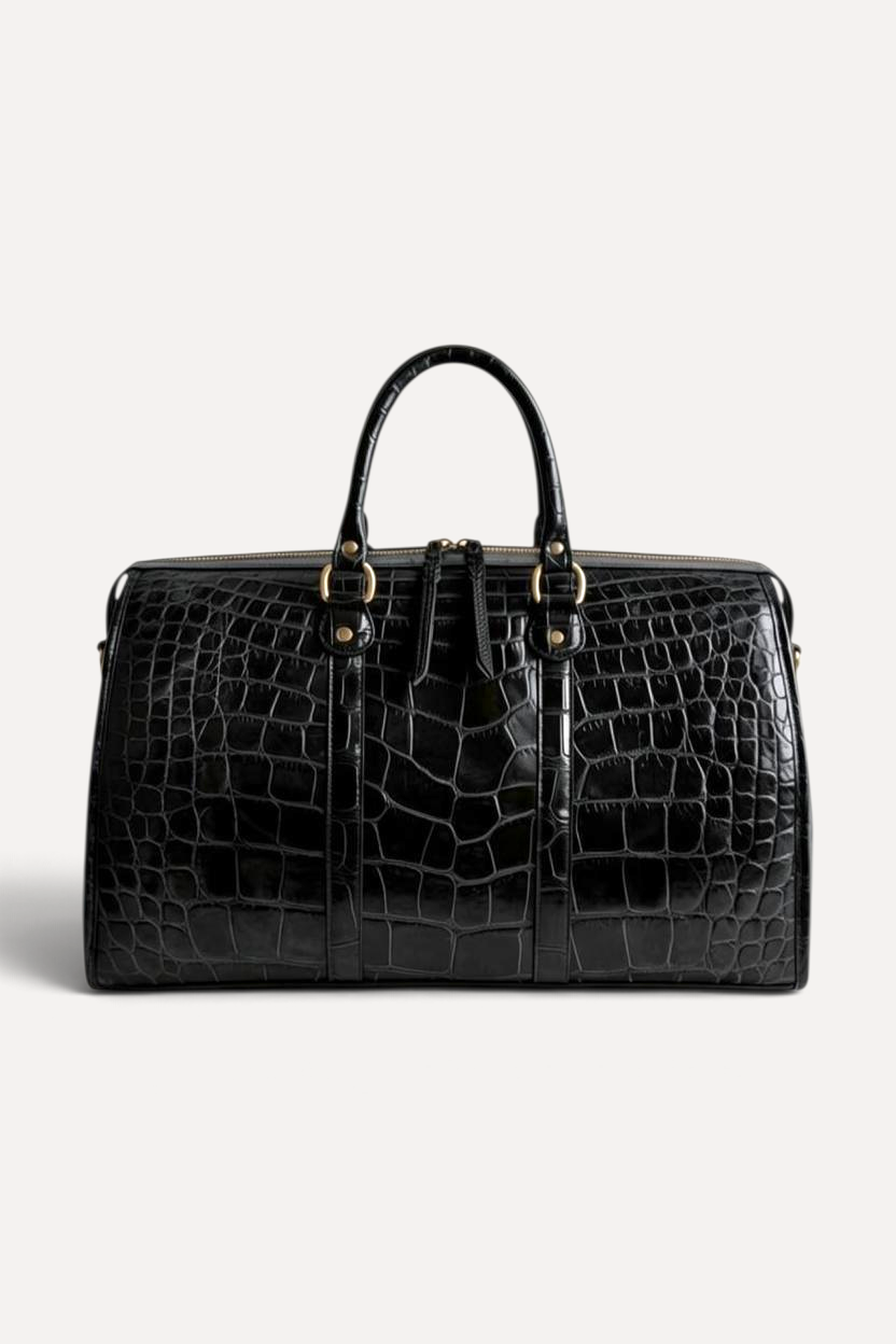 Wilkinson's Fine Goods black American alligator leather weekender bag with hand-matched scales and gold hardware.