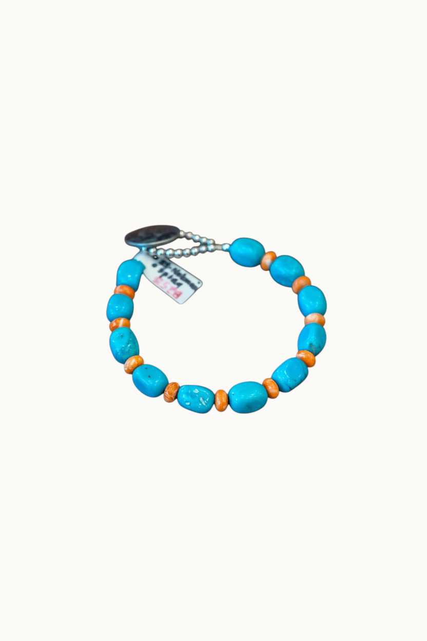 Wilkinson's Fine Goods 7.5 inch bracelet featuring Nakosari turquoise and orange spiny oyster beads with a Mercury dime.