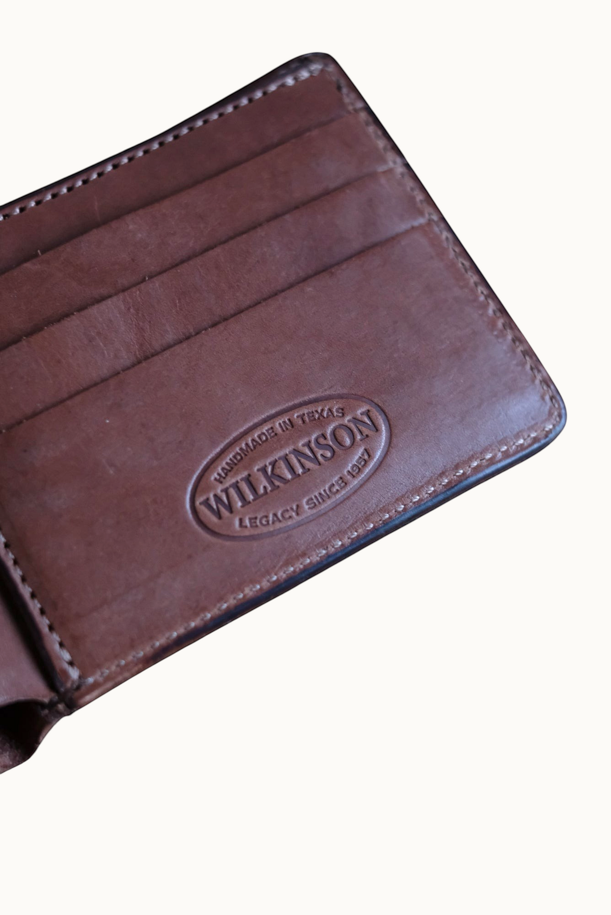 Close-up of embossed Wilkinson Handmade in Texas Legacy Since 1957 stamp inside Classic Billfold