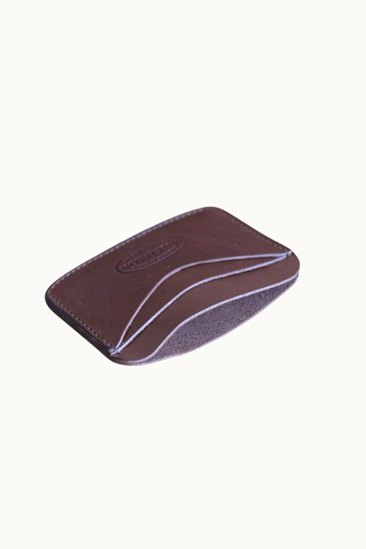Wilkinson's Fine Goods Hickory slim brown leather wallet with four card pockets on a neutral surface