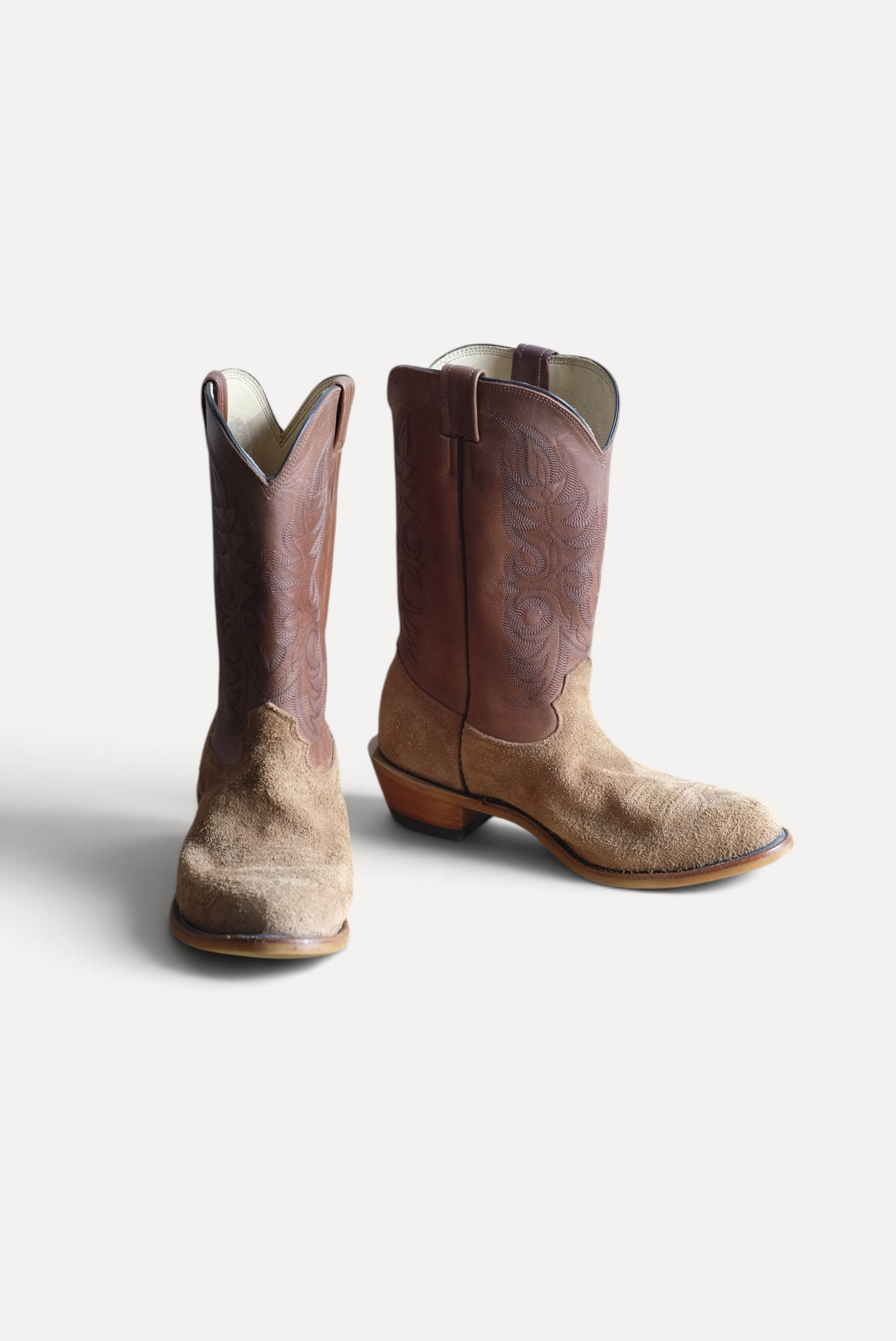 Pair of tan roughout Ranch Hand cowboy boots with brown tops, front view