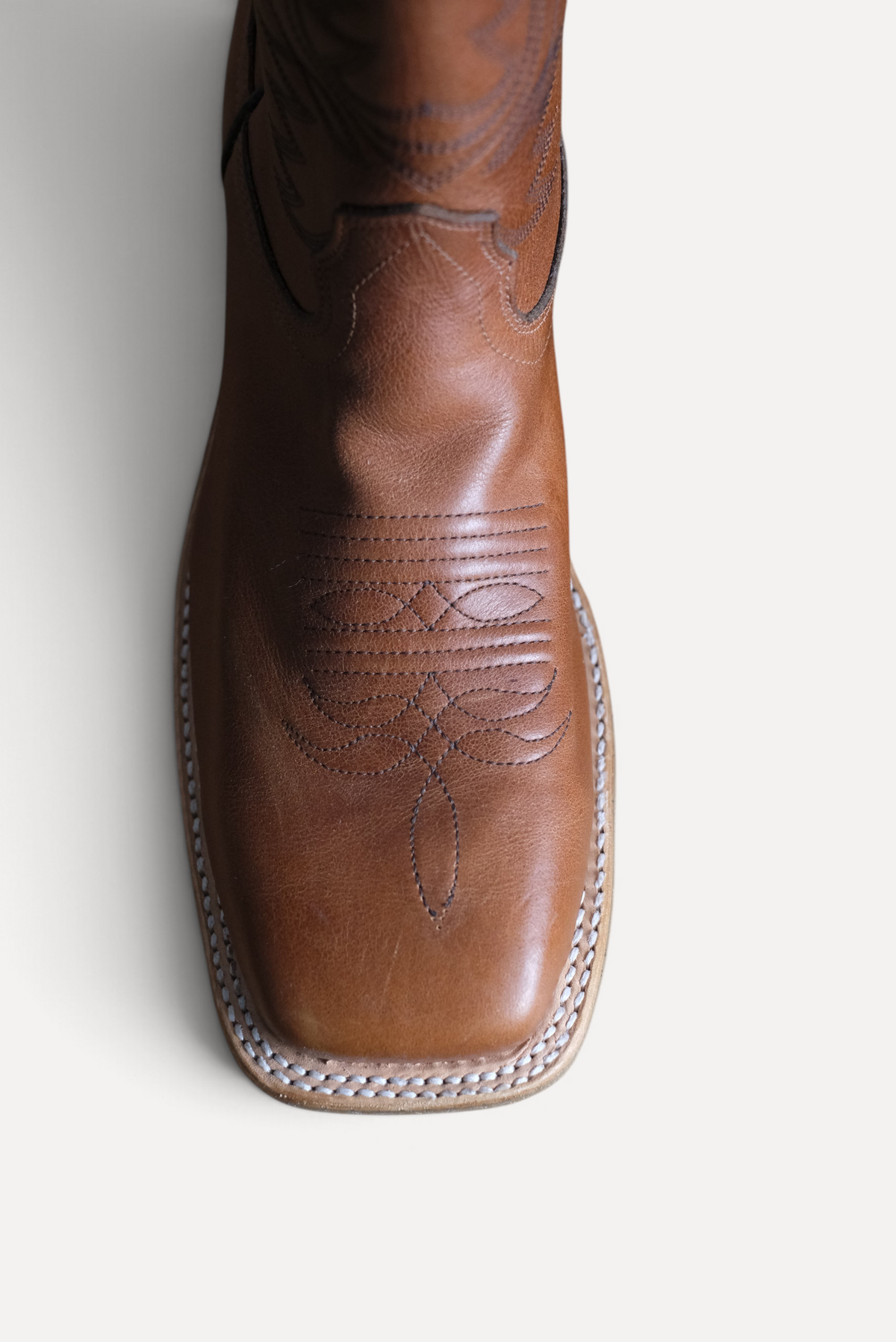 Top down view of cognac OPU square toe with toe stitching and welt