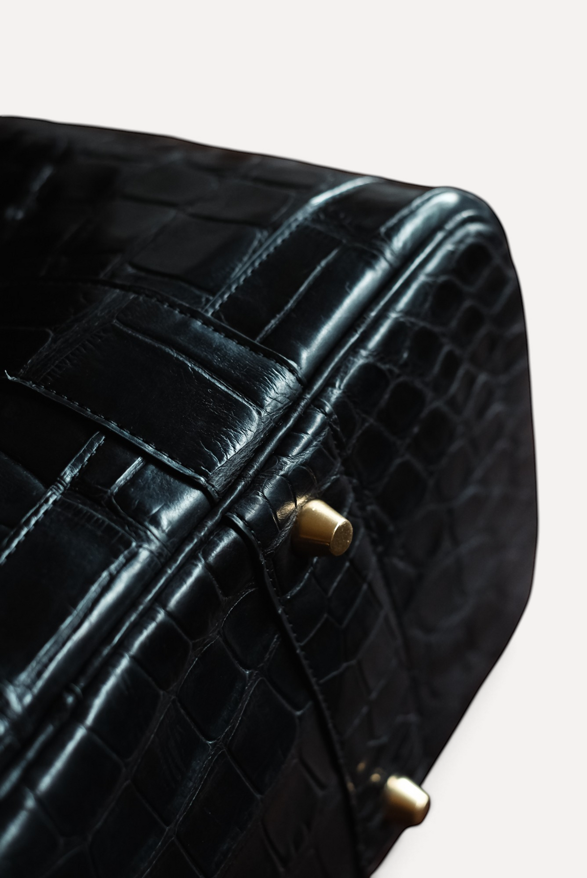 Wilkinson's Fine Goods black American alligator leather Legacy bag featuring brass hardware feet on the base