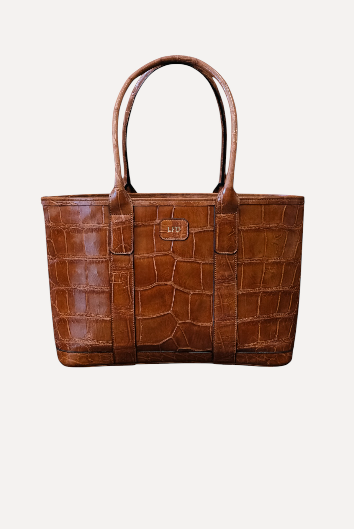 Wilkinson's Fine Goods handmade brown American alligator leather tote bag with rolled handles and brass hardware.
