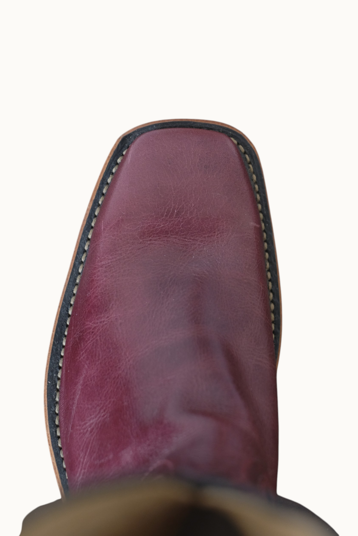 Wilkinson's Fine Goods handmade cowboy boot with a cabernet leather square toe vamp, top-down view.