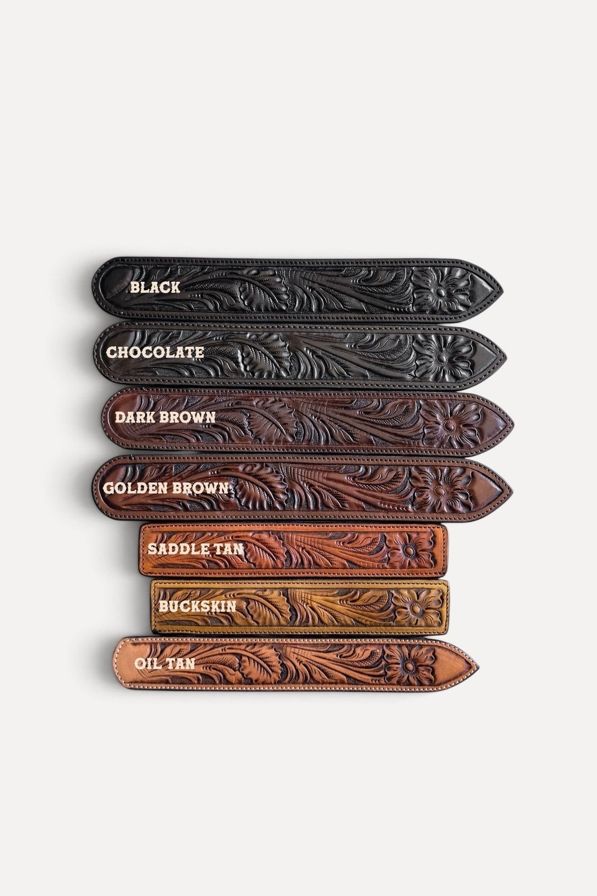 Wilkinson's Fine Goods hand-tooled full-grain leather belts in seven assorted brown and black floral oak leaf shades.