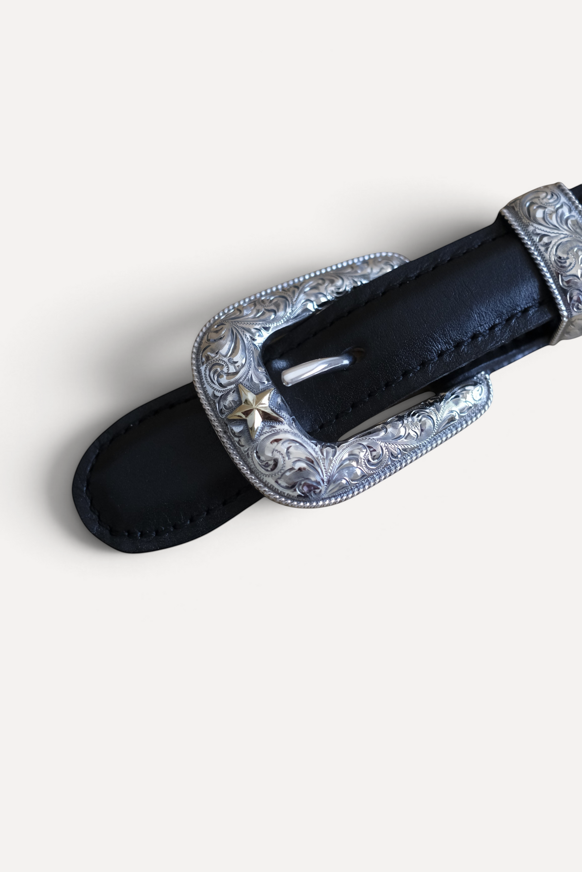 Wilkinson's Fine Goods sterling silver Senator buckle set with 14k gold star and hand-engraved Western detailing.