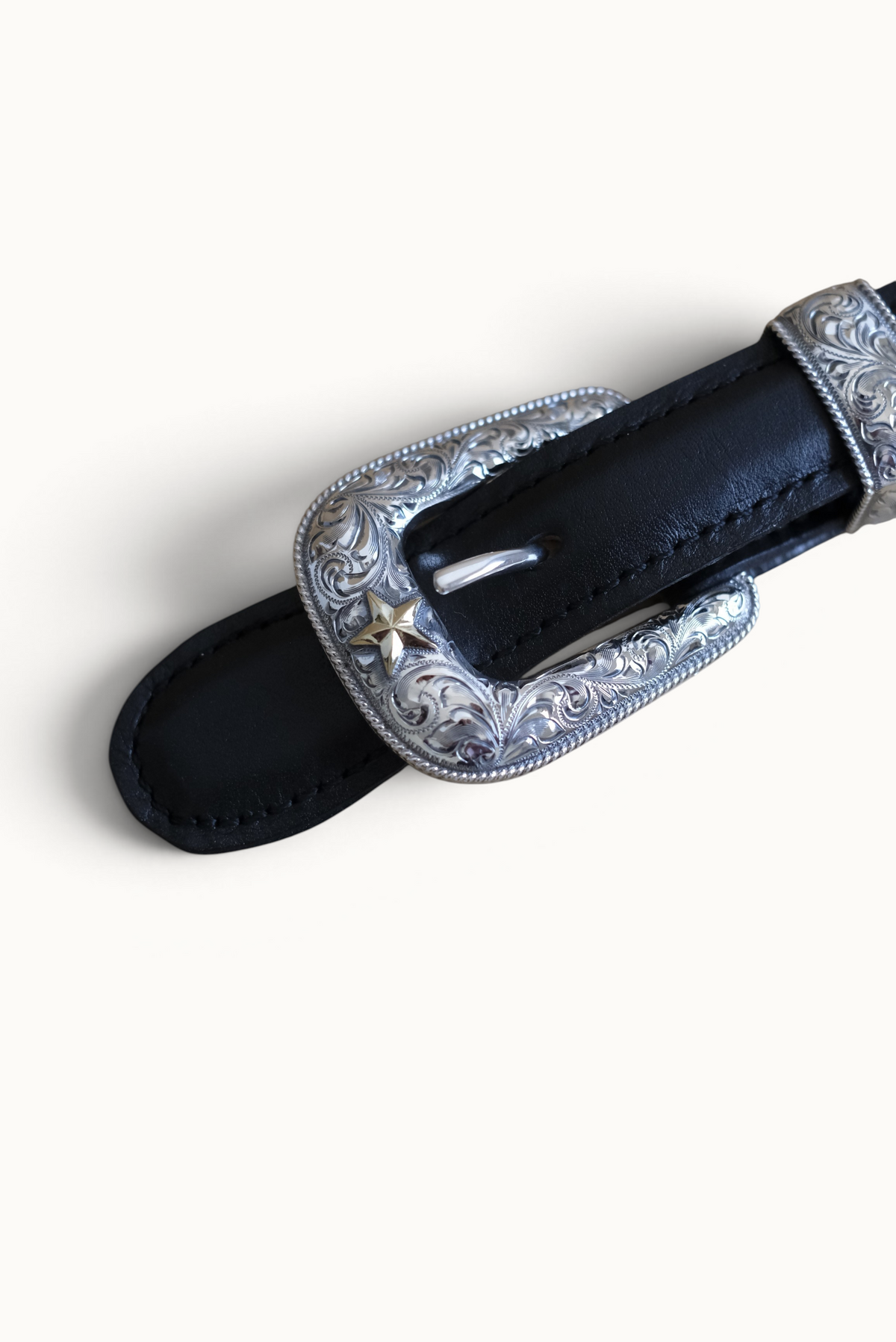 Wilkinson's Fine Goods sterling silver Senator buckle set with 14k gold star and hand-engraved Western detailing.