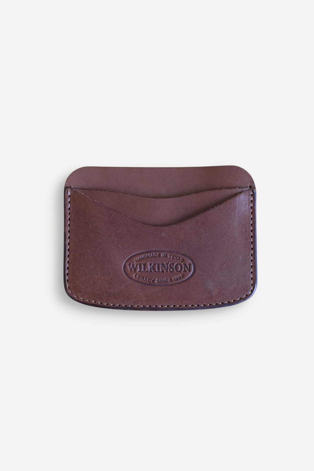 Wilkinson's Fine Goods Hickory slim brown leather card wallet with embossed logo on a neutral background