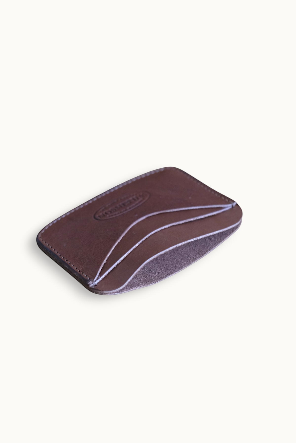 Wilkinson's Fine Goods Hickory slim brown leather wallet with four card pockets on a neutral surface