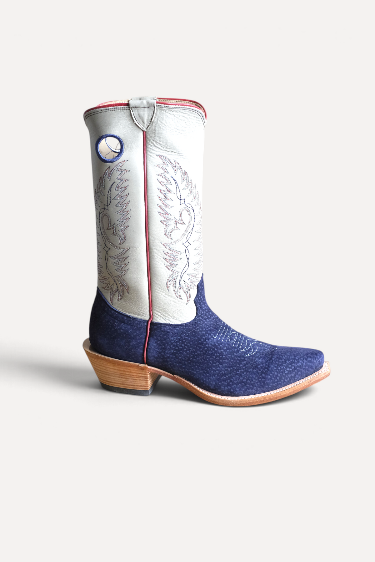 Navy carpincho cowboy boot with a cream embroidered top and red piping, Wilkinson x Scott Slusher, side view