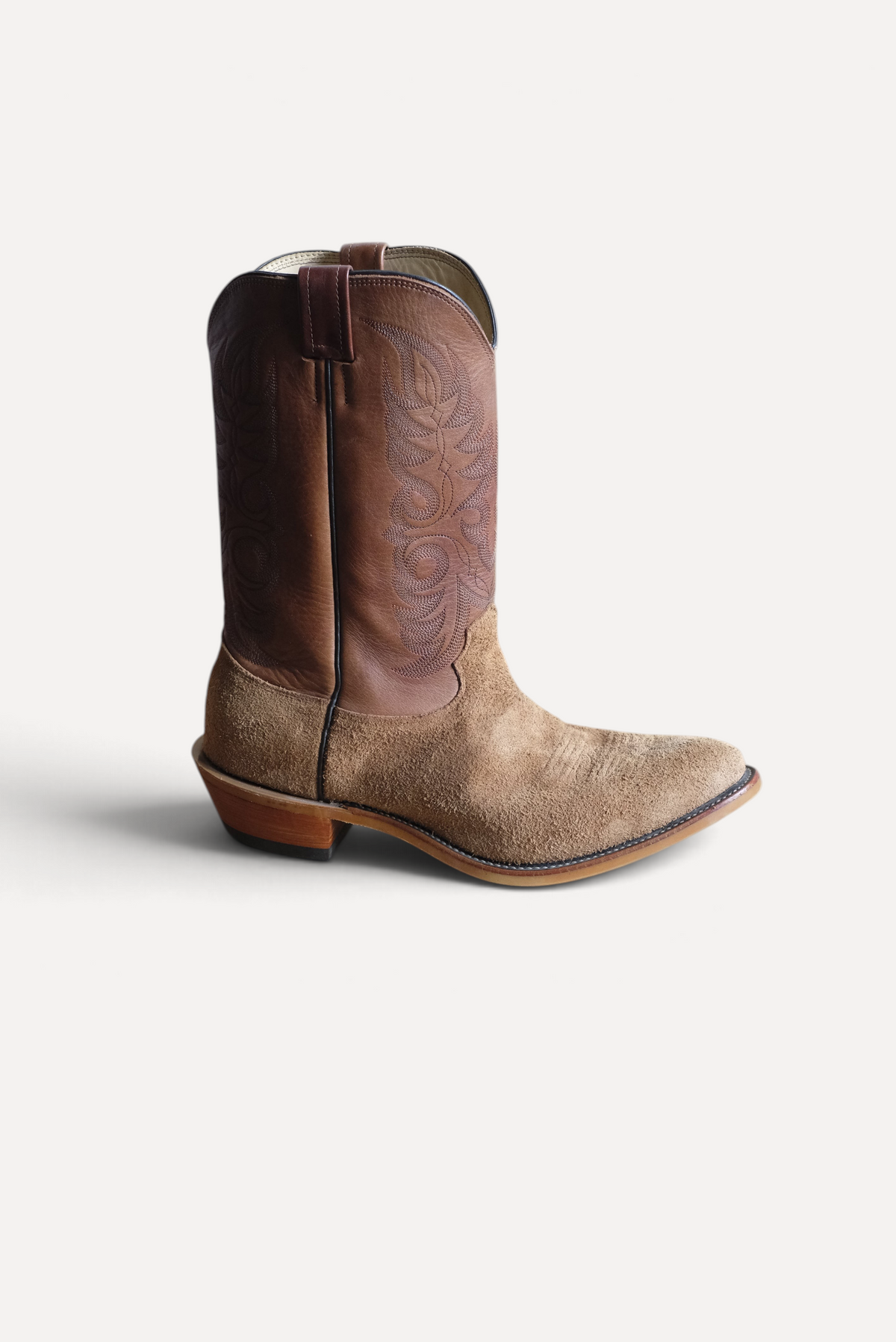 Tan roughout Ranch Hand cowboy boot with a brown leather top, side view