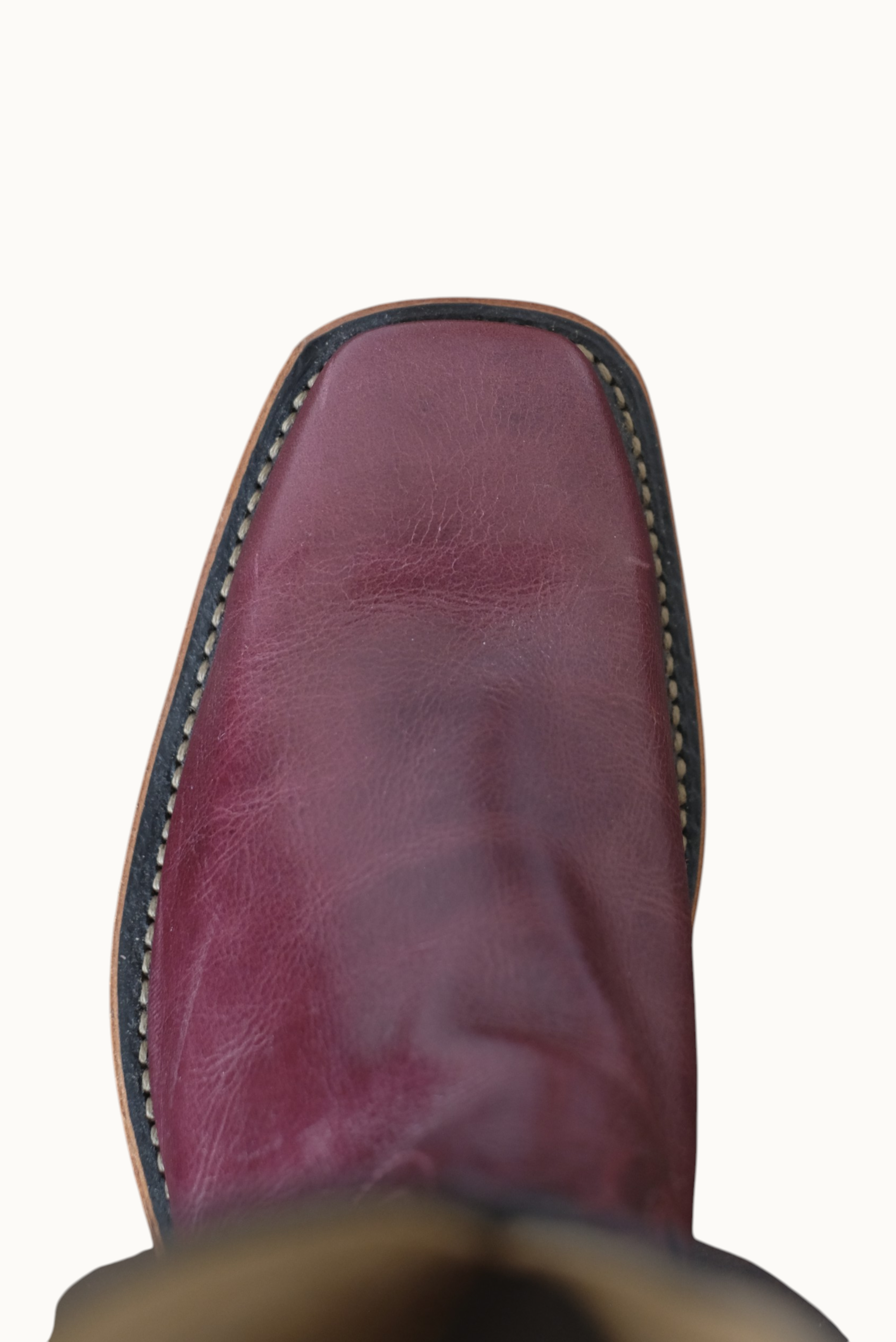 Wilkinson's Fine Goods handmade cowboy boot with a cabernet leather square toe vamp, top-down view.