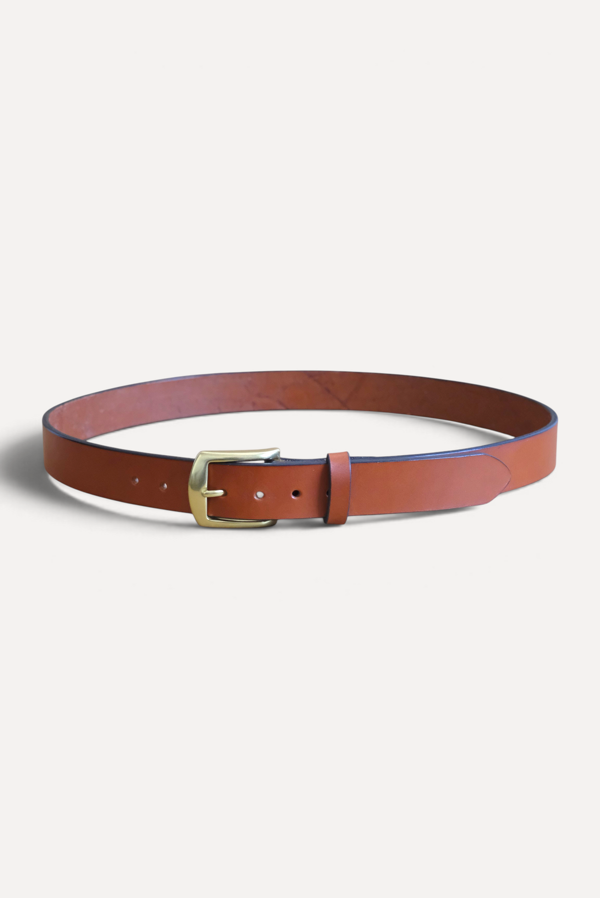 Wilkinson's Fine Goods 1.25 inch chestnut bridle leather belt with a solid brass buckle on a neutral background.